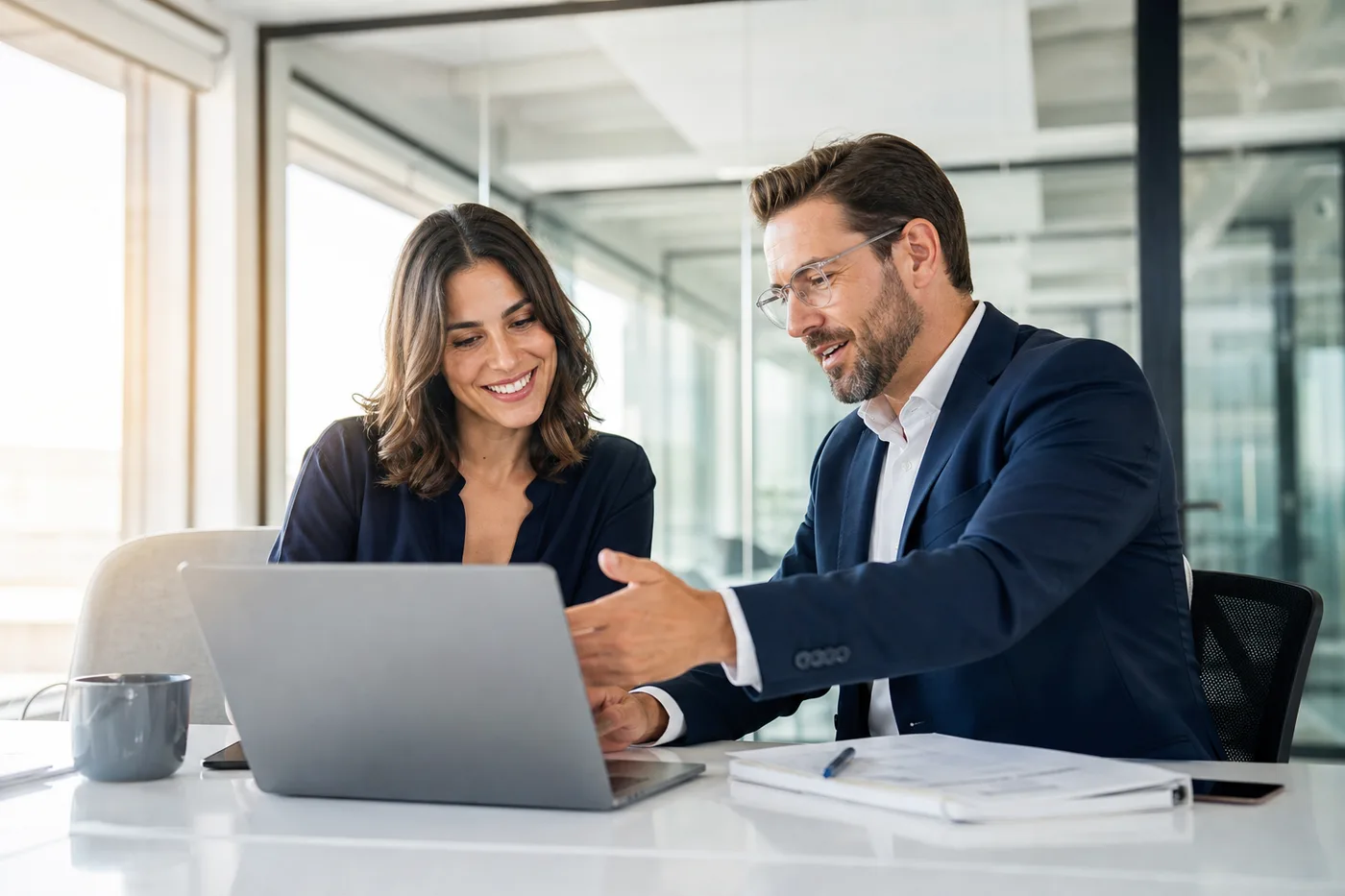 Two professionals collaborating on custom software in a bright modern office